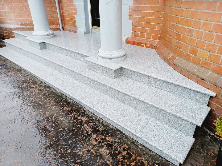 Silver granite steps and landing built between rendered pillars