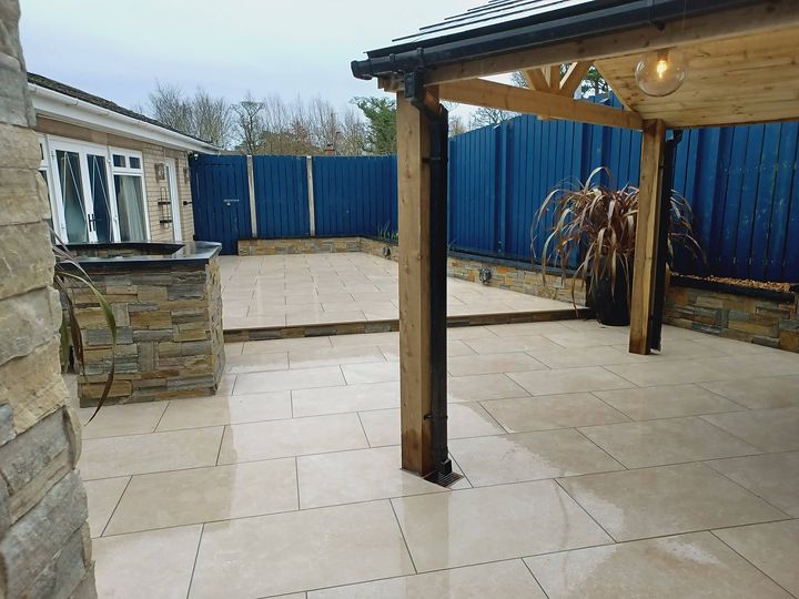 Oak-framed garden room with a slate roof over a porcelain patio