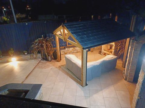 The oak garden room lit up at dusk