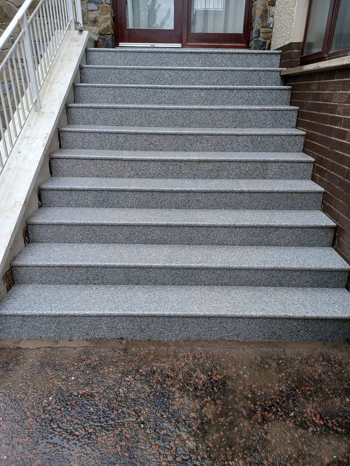 The same steps after work: uniform silver granite treads with bullnose edges
